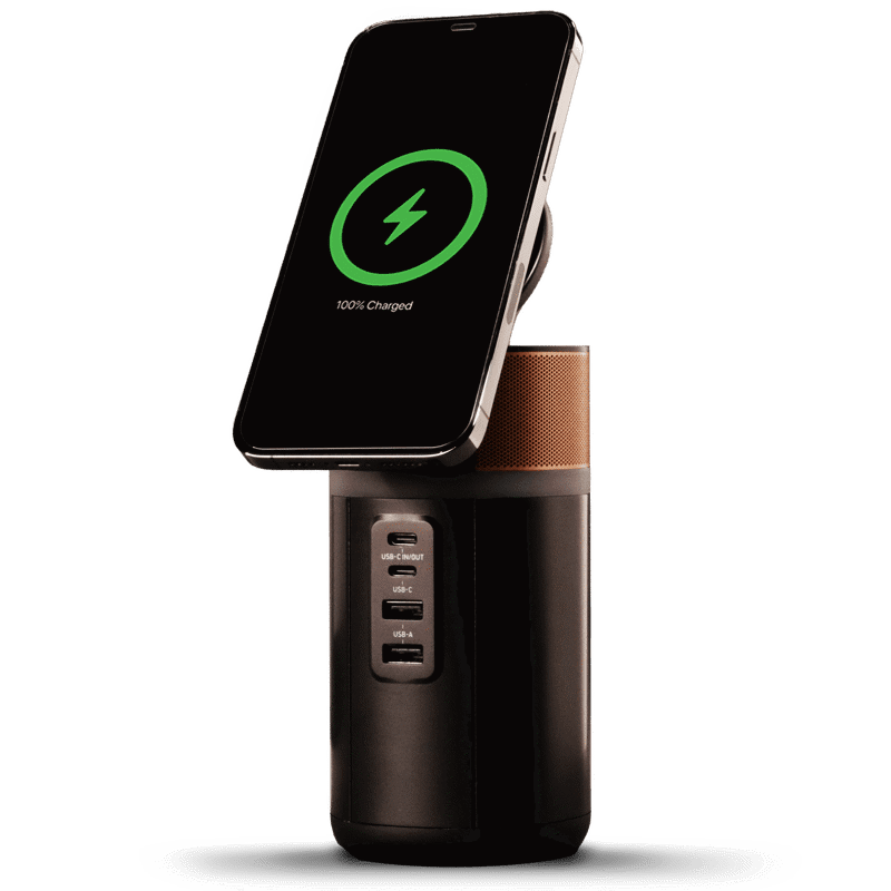 Image of the power station with a phone wirelessly charging on top and the lid tilted up.