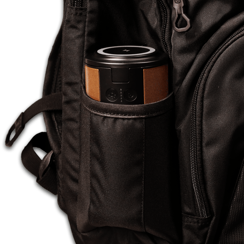 Image of the power station in the water bottle holder of a black backpack.