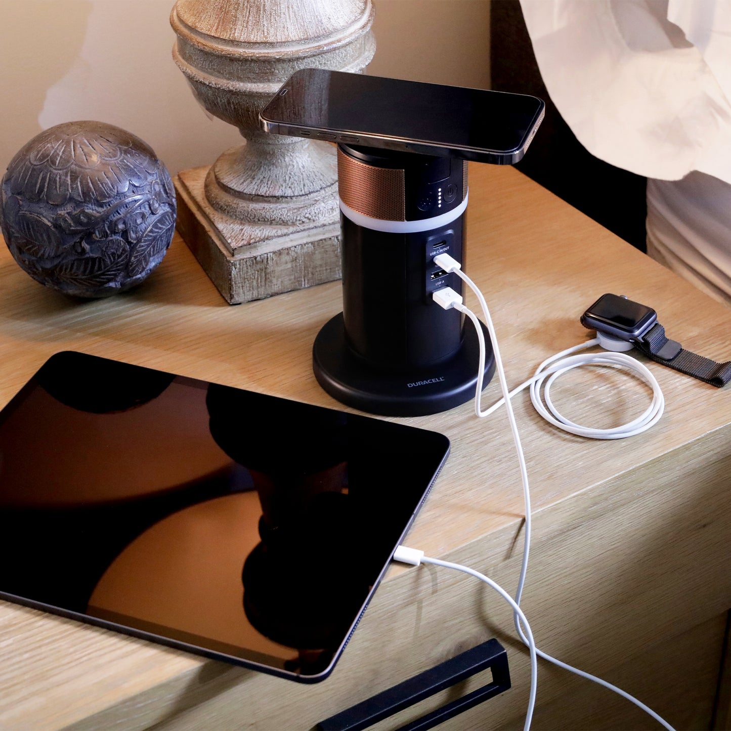 M150 charger bedside table charging a phone and tablet