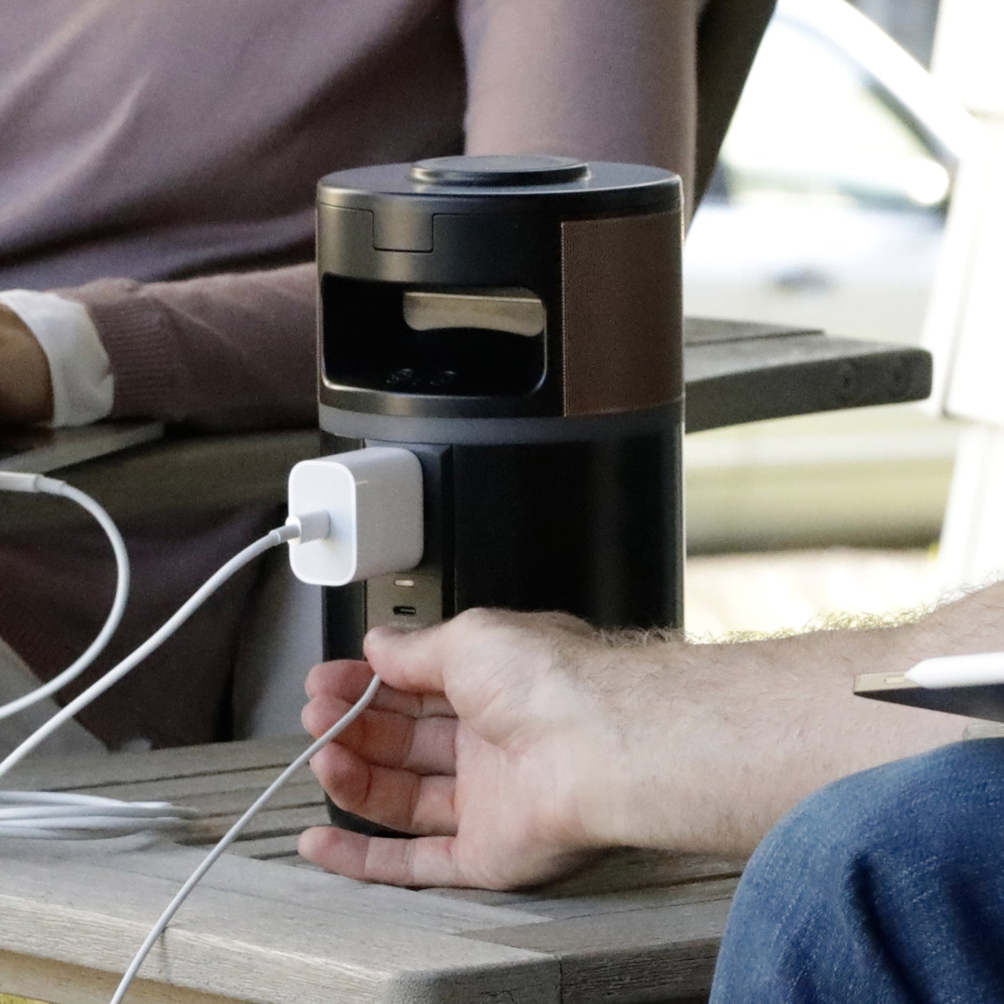 Duracell charging hub powering a laptop outside