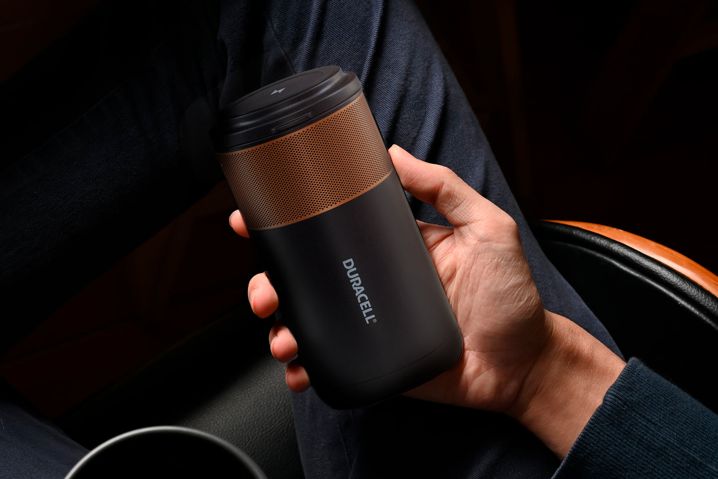 Duracell M100 portable charging hub in a man's hands to show the size in context