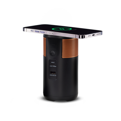 Duracell M100 portable charging hub with the tiltable lid down and a smartphone wirelessly charging on it